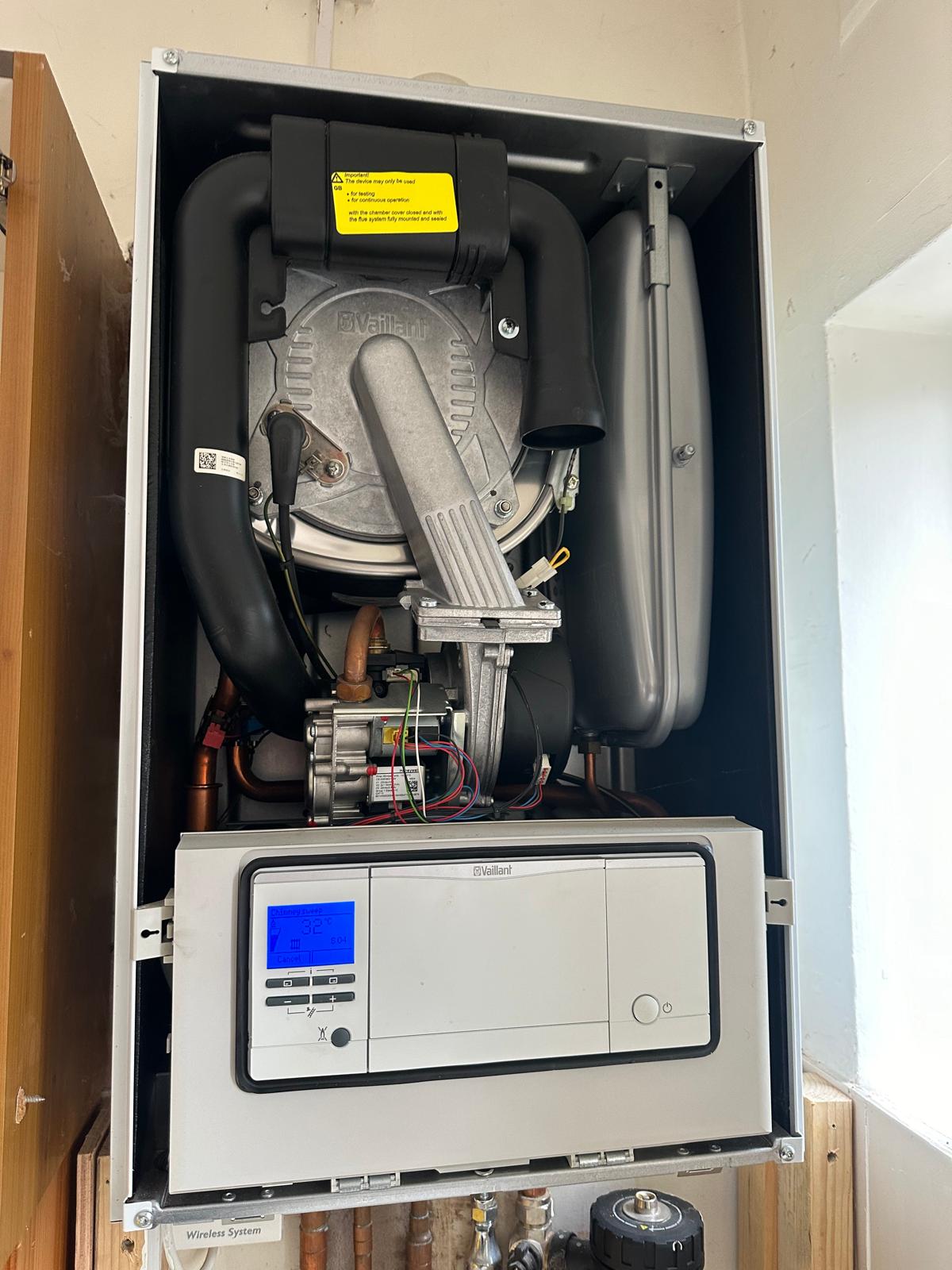 Vaillant boiler with front panel removed running chimney-sweep mode during a full service